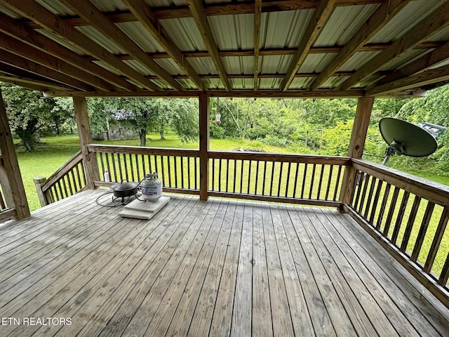wooden terrace featuring a lawn