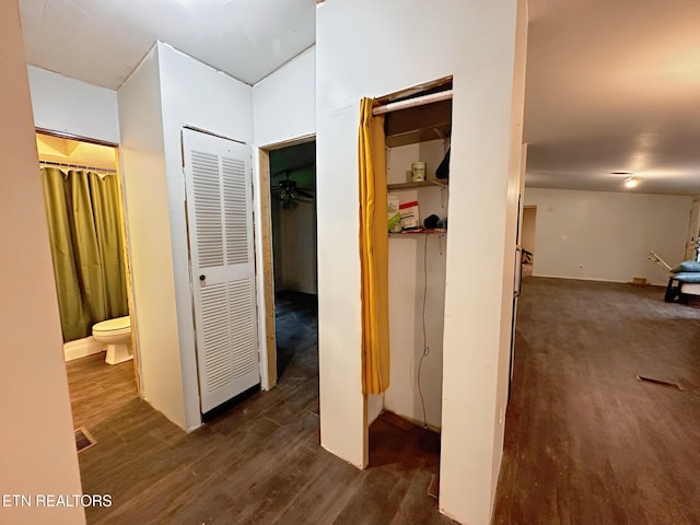 hallway featuring dark wood finished floors and a heating unit