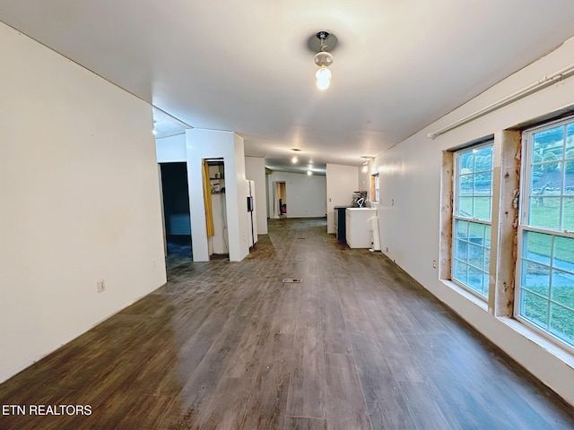 unfurnished living room featuring dark wood-style floors