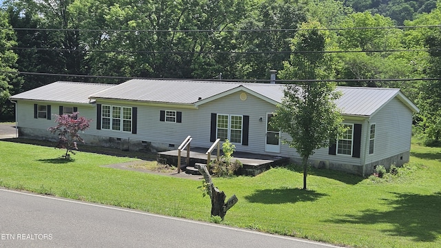 view of front of property with crawl space, a front yard, and metal roof