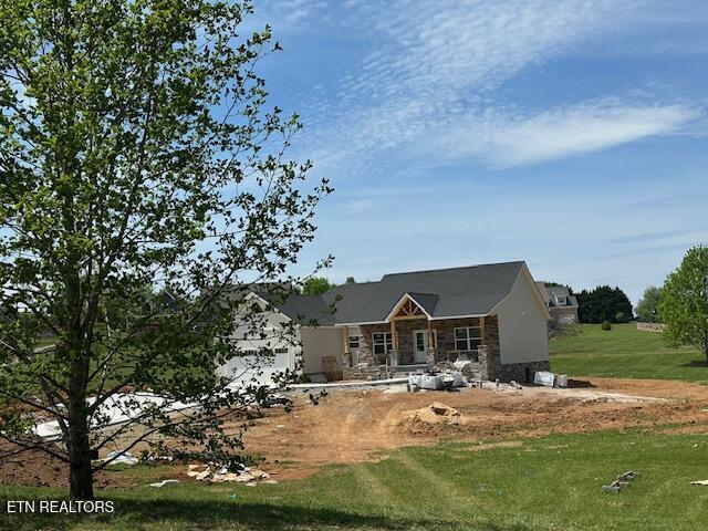 273 Sugar Maple Ct, Madisonville, TN 37354 - back of house featuring stone siding and a lawn