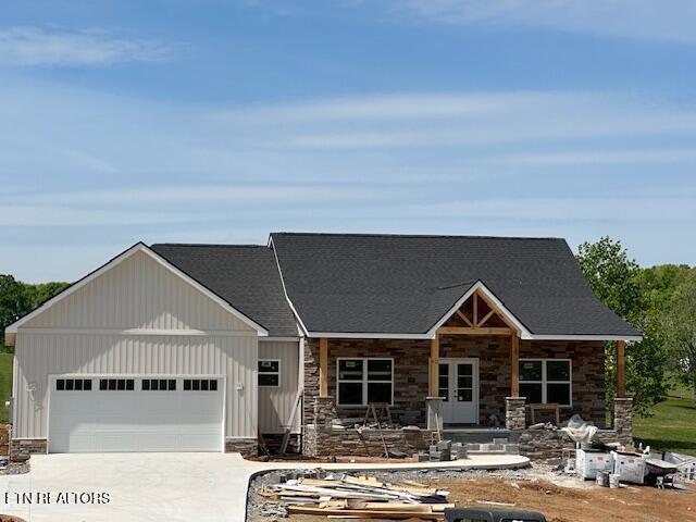 273 Sugar Maple Ct, Madisonville, TN 37354 - view of front of home featuring an attached garage, stone siding, and concrete driveway