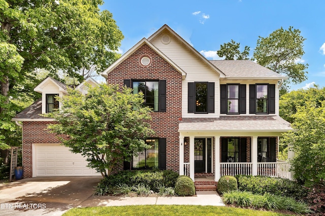 714 Cambridge Crest Ln, Knoxville, TN 37919 - view of front of home featuring covered porch, concrete driveway, brick siding, a garage, and a shingled roof