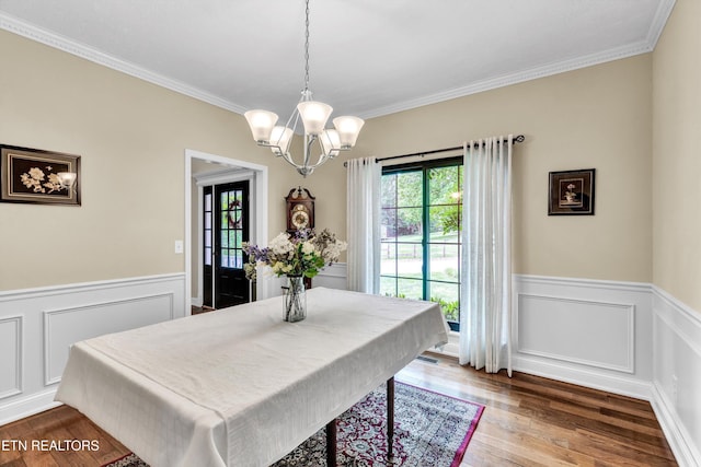 714 Cambridge Crest Ln, Knoxville, TN 37919 - dining room featuring a chandelier, wainscoting, ornamental molding, wood finished floors, and a decorative wall
