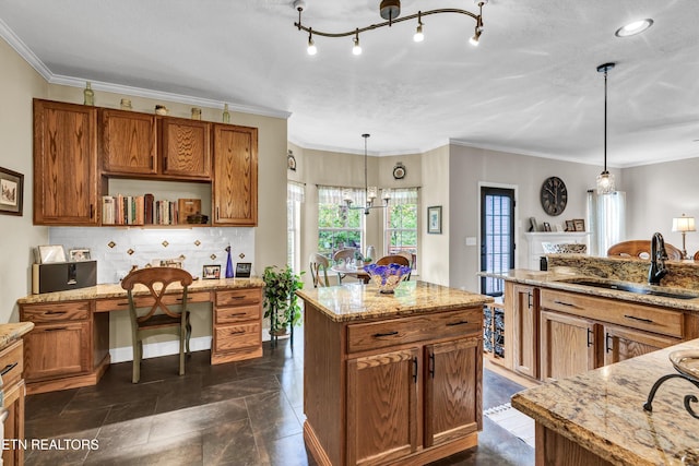 714 Cambridge Crest Ln, Knoxville, TN 37919 - kitchen with brown cabinetry, a sink, pendant lighting, light stone counters, and decorative backsplash