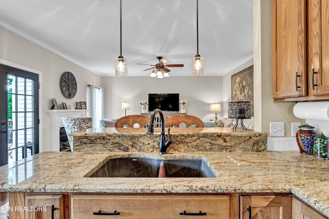 714 Cambridge Crest Ln, Knoxville, TN 37919 - kitchen with a sink, light stone countertops, crown molding, open floor plan, and pendant lighting