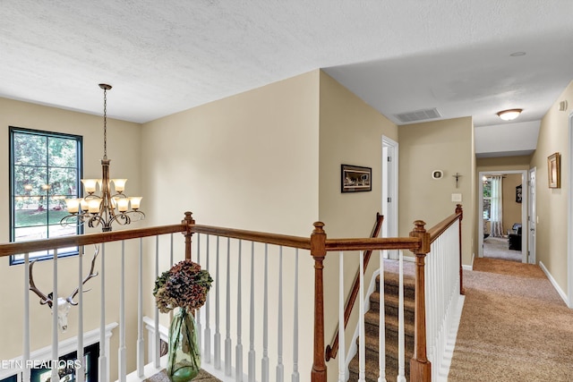 714 Cambridge Crest Ln, Knoxville, TN 37919 - hallway featuring carpet floors, a chandelier, an upstairs landing, a textured ceiling, and baseboards