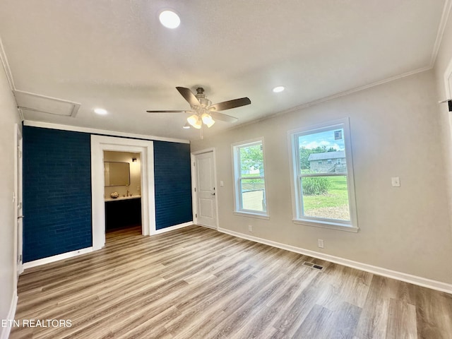 empty room with baseboards, light wood-style flooring, ornamental molding, ceiling fan, and recessed lighting
