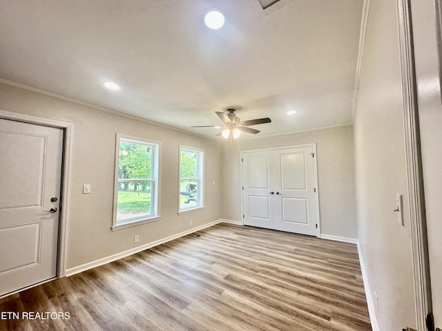unfurnished bedroom with ornamental molding, wood finished floors, baseboards, recessed lighting, and ceiling fan