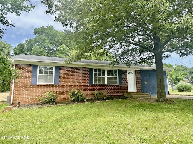 ranch-style house with a front lawn and brick siding