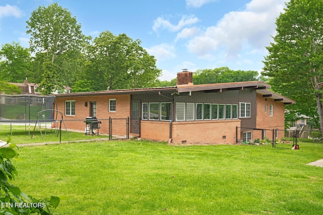 8000 Berkshire Blvd, Powell, TN 37849 - rear view of property featuring a trampoline, brick siding, a chimney, and a gate