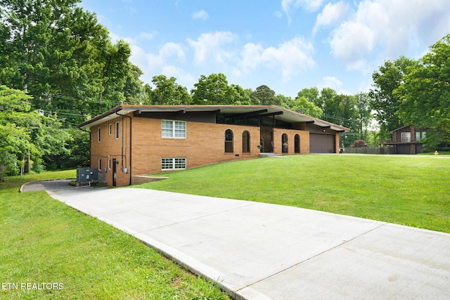 8000 Berkshire Blvd, Powell, TN 37849 - view of front of property with a front lawn, driveway, brick siding, and a garage