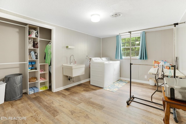 8000 Berkshire Blvd, Powell, TN 37849 - washroom with washing machine and clothes dryer, wood finished floors, a textured ceiling, and baseboards