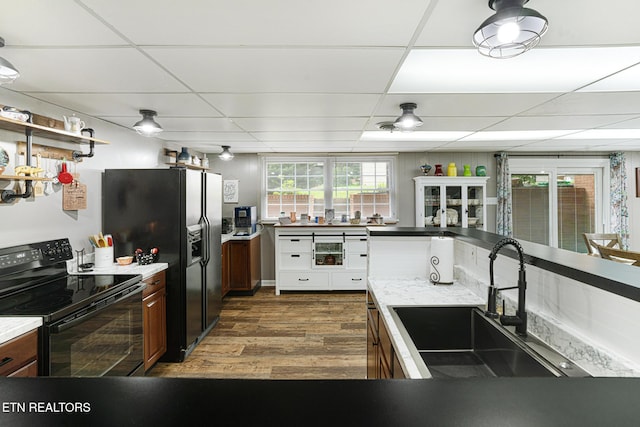8000 Berkshire Blvd, Powell, TN 37849 - kitchen with black appliances, a sink, a drop ceiling, dark wood-style floors, and light countertops