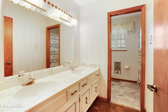 8000 Berkshire Blvd, Powell, TN 37849 - bathroom featuring toilet, double vanity, baseboards, and heating unit