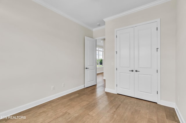 1123 Branch Hook Rd, Knoxville, TN 37934 - unfurnished bedroom with ornamental molding, light wood-type flooring, baseboards, and a closet