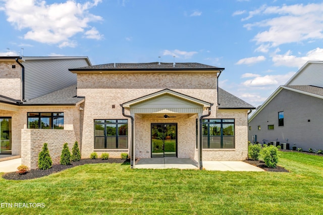 1123 Branch Hook Rd, Knoxville, TN 37934 - back of property with brick siding, a patio area, a lawn, ceiling fan, and roof with shingles