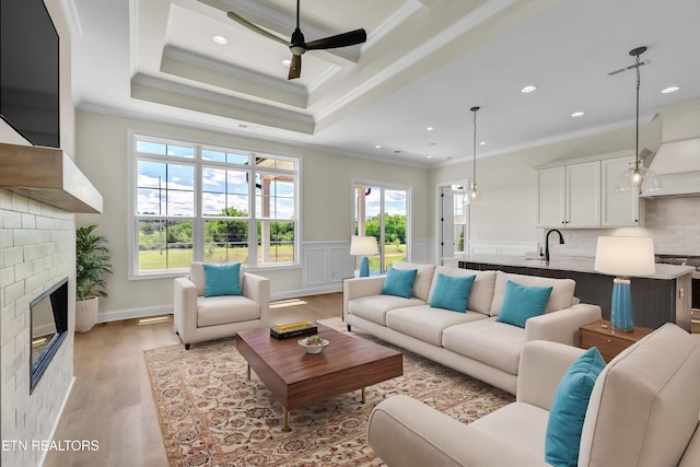 1123 Branch Hook Rd, Knoxville, TN 37934 - living area with ornamental molding, ceiling fan, light wood-style flooring, a fireplace, and plenty of natural light