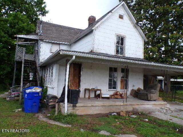 941 Unaka St, Harriman, TN 37748 - rear view of property with covered porch, stairs, and a chimney