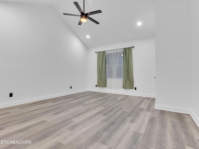 spare room with ceiling fan, high vaulted ceiling, baseboards, wood finished floors, and recessed lighting