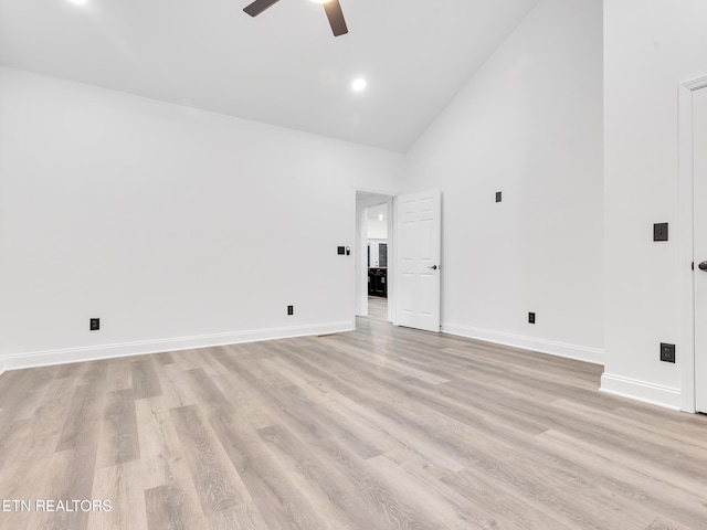 unfurnished room featuring high vaulted ceiling, ceiling fan, light wood-type flooring, and baseboards