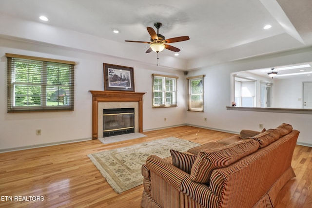 11 Kingsboro Ln, Crossville, TN 38558 - living room featuring light wood-style flooring, a ceiling fan, a tiled fireplace, baseboards, and recessed lighting