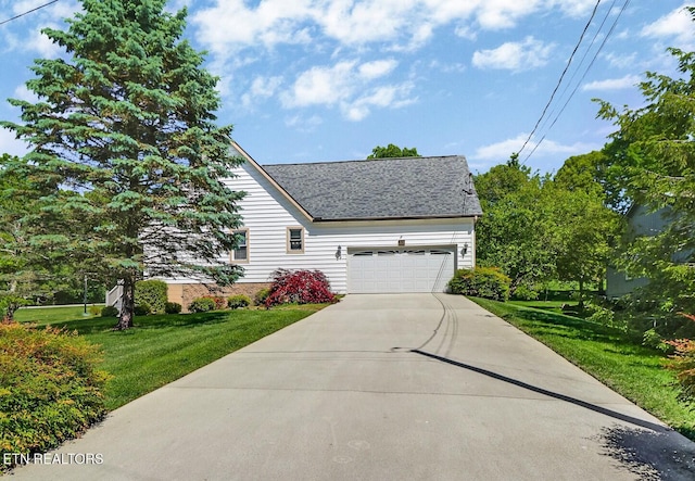 11 Kingsboro Ln, Crossville, TN 38558 - view of front of property featuring a front yard, concrete driveway, an attached garage, and roof with shingles