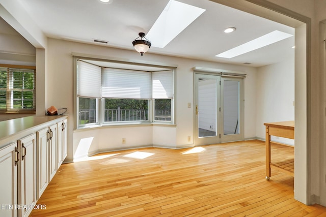 11 Kingsboro Ln, Crossville, TN 38558 - unfurnished dining area featuring a skylight, light wood-style flooring, baseboards, and recessed lighting
