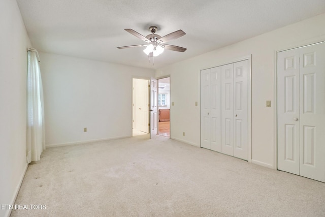 11 Kingsboro Ln, Crossville, TN 38558 - unfurnished bedroom with carpet flooring, multiple closets, baseboards, and a ceiling fan