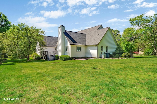 11 Kingsboro Ln, Crossville, TN 38558 - back of house with a lawn, a chimney, a shingled roof, and central air condition unit