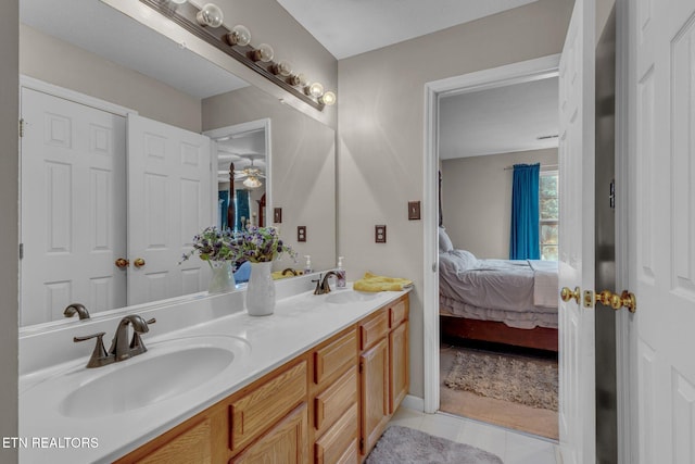 bathroom with ensuite bath, tile patterned flooring, double vanity, and a ceiling fan