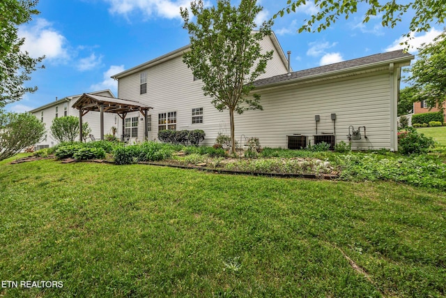rear view of house featuring a gazebo, a lawn, and cooling unit
