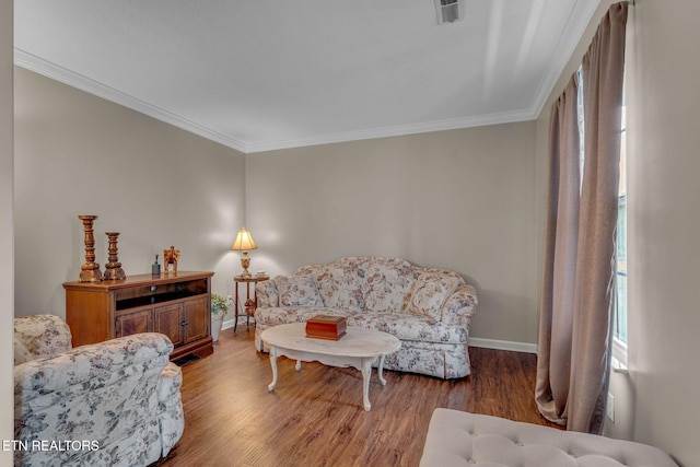 living area featuring wood finished floors, ornamental molding, and baseboards
