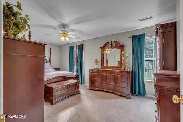 bedroom with light colored carpet, ceiling fan, and baseboards