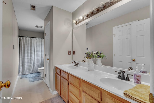 full bath featuring double vanity, toilet, baseboards, and tile patterned flooring