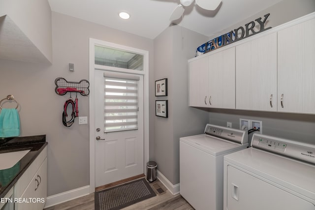 109 Niwodihi Trl, Vonore, TN 37885 - clothes washing area featuring cabinet space, separate washer and dryer, light wood finished floors, and baseboards