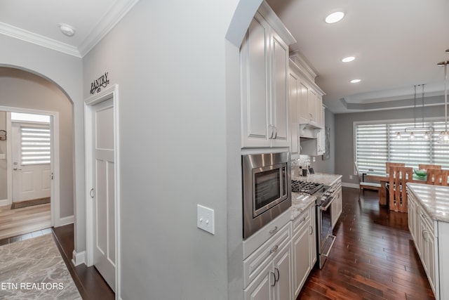109 Niwodihi Trl, Vonore, TN 37885 - kitchen featuring stainless steel appliances, white cabinets, dark wood finished floors, healthy amount of natural light, and ornamental molding