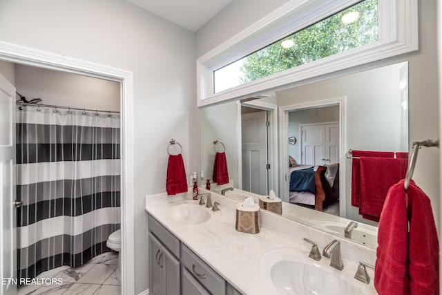 109 Niwodihi Trl, Vonore, TN 37885 - bathroom featuring marble look tile flooring, double vanity, toilet, connected bathroom, and curtained shower