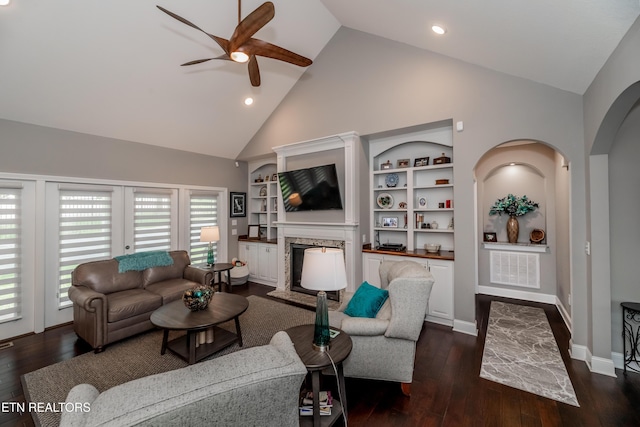 109 Niwodihi Trl, Vonore, TN 37885 - living room featuring ceiling fan, high vaulted ceiling, a fireplace with raised hearth, arched walkways, and built in features