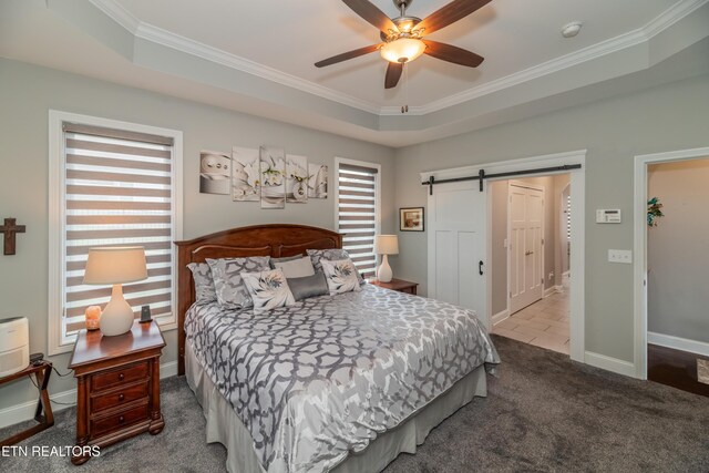 109 Niwodihi Trl, Vonore, TN 37885 - carpeted bedroom featuring crown molding, a barn door, a tray ceiling, baseboards, and ceiling fan