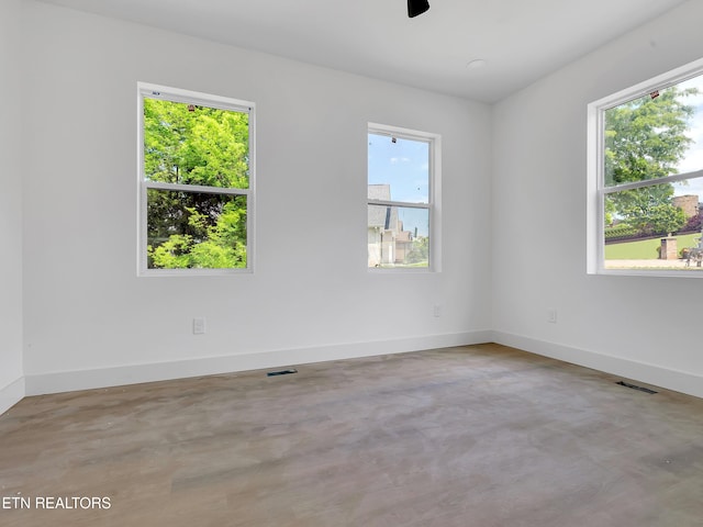 1715 Serene Cove Way, Knoxville, TN 37920 - empty room with finished concrete flooring, baseboards, and ceiling fan