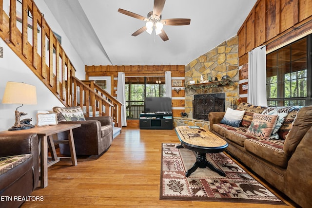 3364 Rocky Ridge Rd, Cosby, TN 37722 - living area featuring stairway, light wood-style flooring, a ceiling fan, vaulted ceiling, and a fireplace