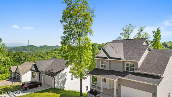 3966 Mountain Vista Rd, Knoxville, TN 37931 - view of front of house featuring a garage, a front lawn, driveway, and roof with shingles