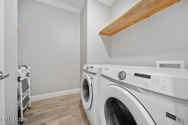3966 Mountain Vista Rd, Knoxville, TN 37931 - clothes washing area featuring ornamental molding, separate washer and dryer, light wood-style flooring, and baseboards