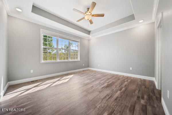 3966 Mountain Vista Rd, Knoxville, TN 37931 - empty room with ornamental molding, a raised ceiling, wood finished floors, baseboards, and a ceiling fan