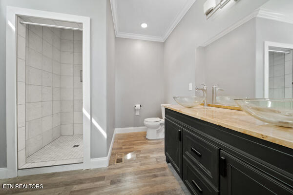 3966 Mountain Vista Rd, Knoxville, TN 37931 - full bath featuring crown molding, wood finished floors, toilet, tiled shower, and double vanity