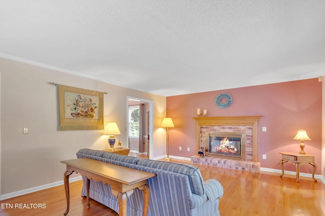 4820 Edens View Rd, Kingsport, TN 37664 - living room featuring crown molding, wood finished floors, a brick fireplace, and a textured ceiling