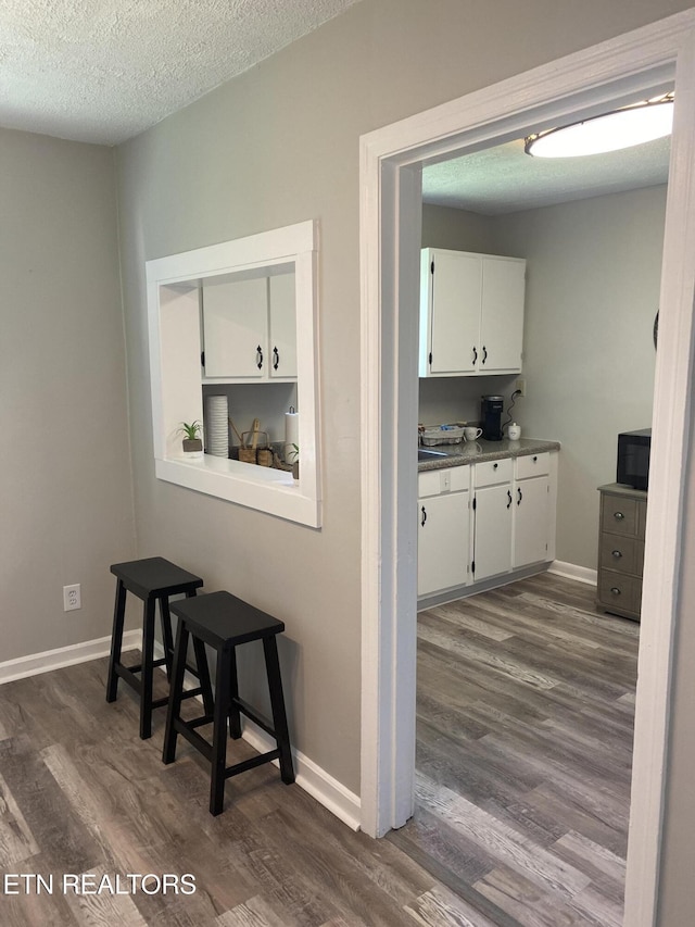 2010 Fine Ave, Knoxville, TN 37917 - hall with dark wood-type flooring, a textured ceiling, and baseboards