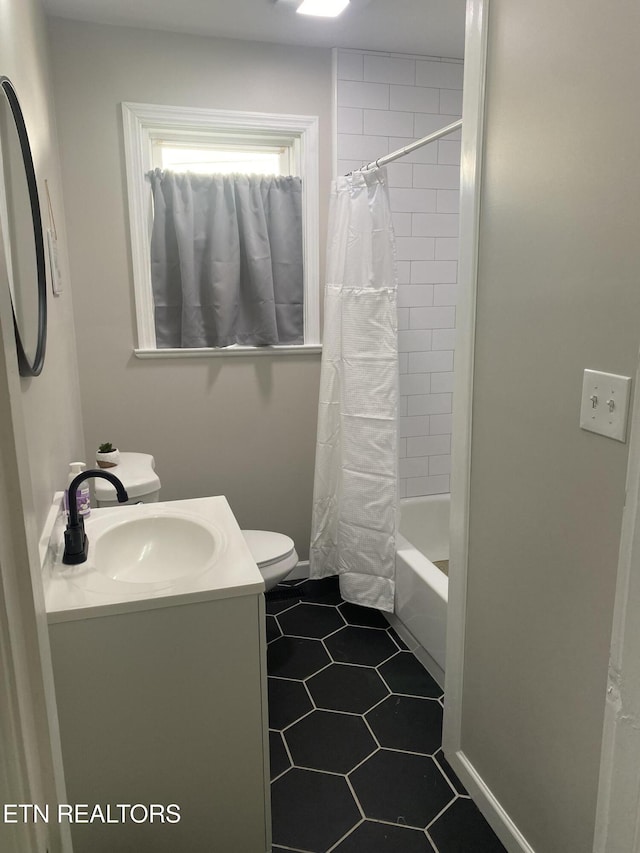 2010 Fine Ave, Knoxville, TN 37917 - bathroom featuring toilet, vanity, tile patterned floors, and shower / tub combo with curtain