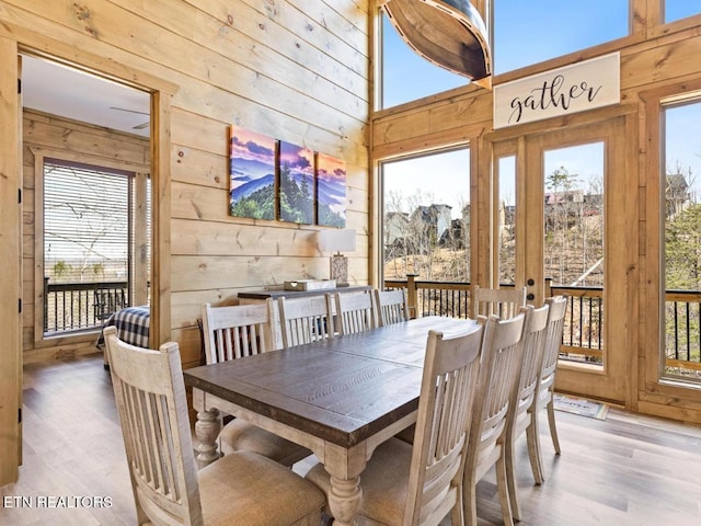 dining area with wood walls and wood finished floors